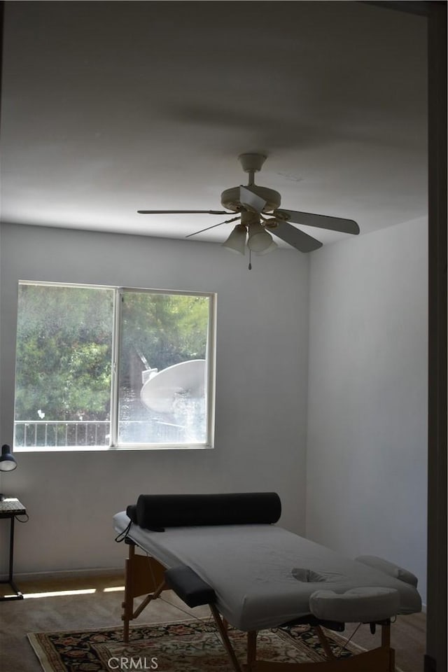 sitting room featuring ceiling fan