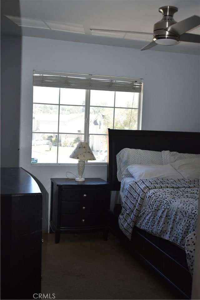 bedroom with ceiling fan and multiple windows