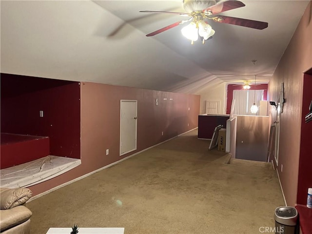 bonus room featuring ceiling fan, vaulted ceiling, and carpet flooring