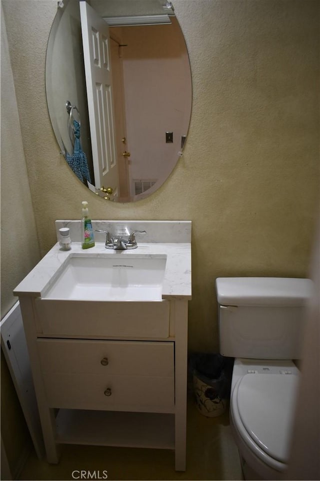 bathroom with toilet and vanity