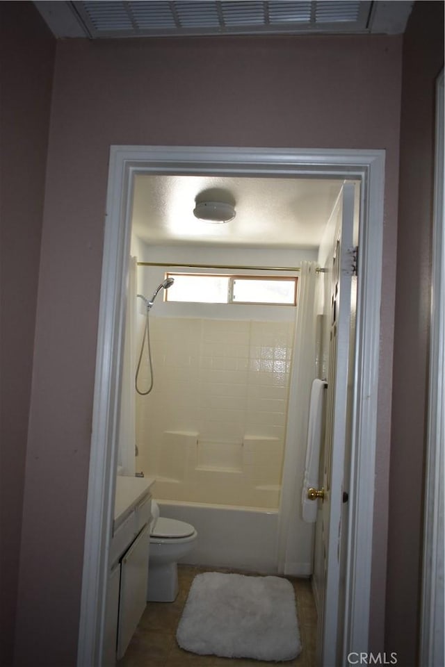 full bathroom with toilet, vanity, tile patterned flooring, and shower / bath combo with shower curtain