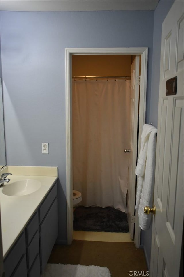 bathroom featuring toilet and vanity