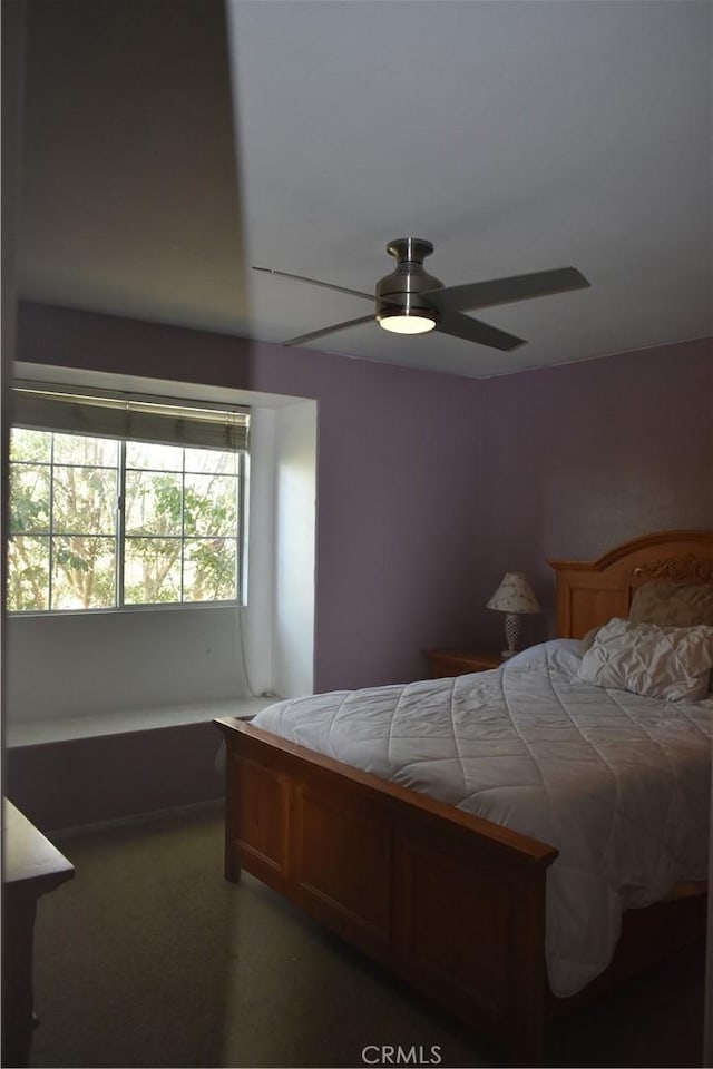 bedroom with ceiling fan and carpet