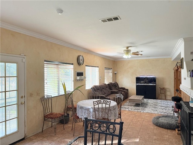 interior space featuring ceiling fan, crown molding, and light tile patterned flooring