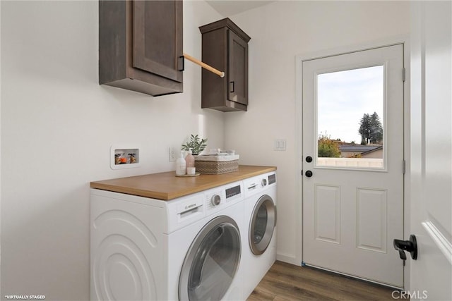 clothes washing area with dark hardwood / wood-style flooring, cabinets, and separate washer and dryer