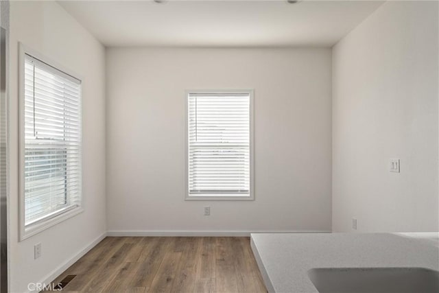 interior space featuring dark hardwood / wood-style flooring and a wealth of natural light