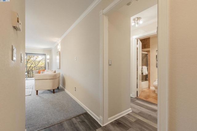 hall with hardwood / wood-style floors and crown molding