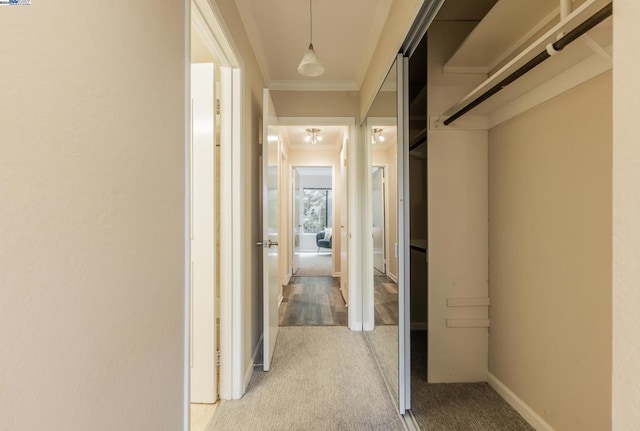 hallway with light carpet and ornamental molding