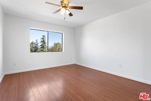 unfurnished room with hardwood / wood-style flooring and ceiling fan