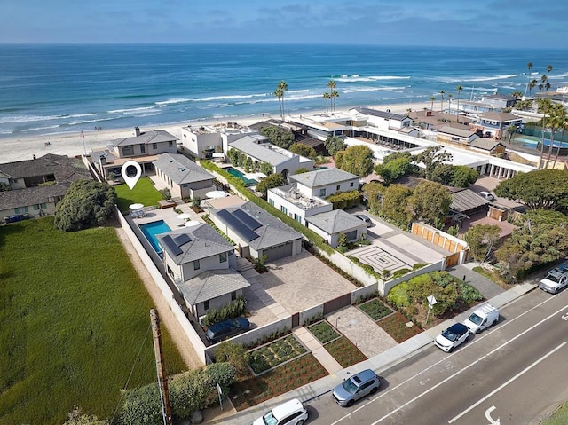 birds eye view of property featuring a water view and a beach view