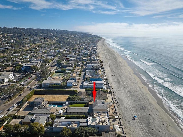 birds eye view of property with a beach view and a water view