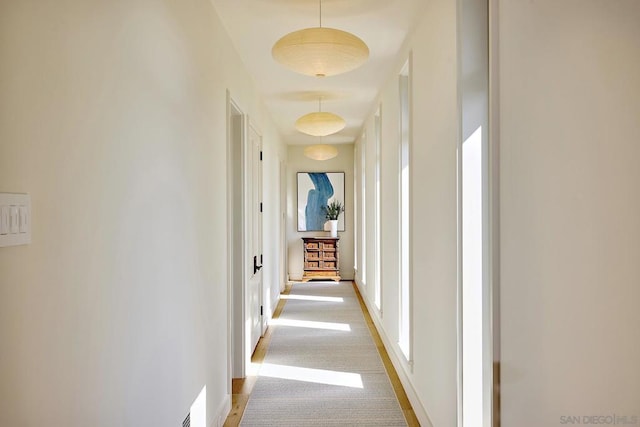 corridor with light colored carpet