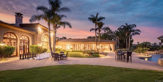 patio terrace at dusk with a lawn