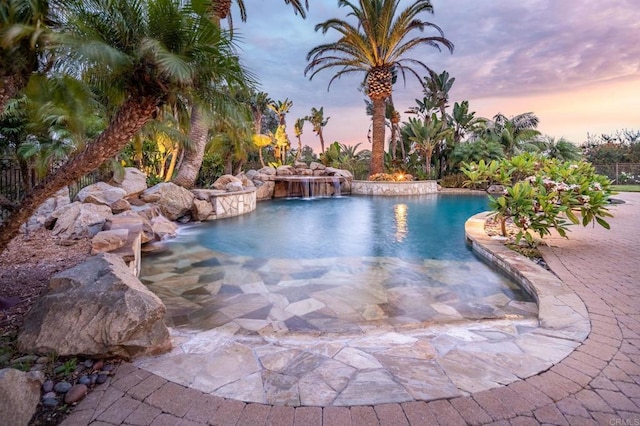 pool at dusk with pool water feature