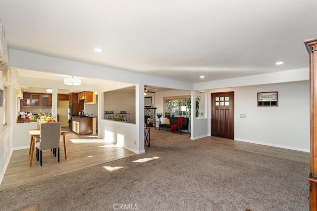 carpeted entrance foyer with ceiling fan