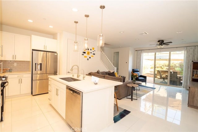 kitchen featuring sink, ceiling fan, an island with sink, white cabinetry, and stainless steel appliances