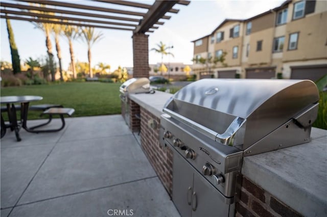 view of patio / terrace with a pergola, area for grilling, and exterior kitchen