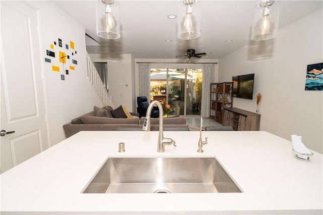 kitchen with ceiling fan, sink, and decorative light fixtures