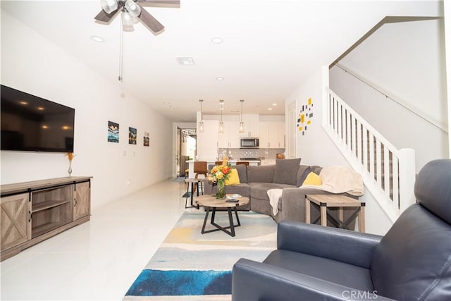 living room featuring light tile patterned floors and ceiling fan