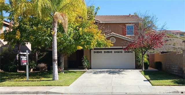 view of front of house featuring a front yard and a garage