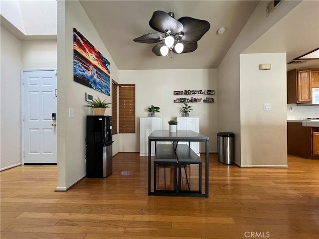 hall with a skylight and light hardwood / wood-style flooring