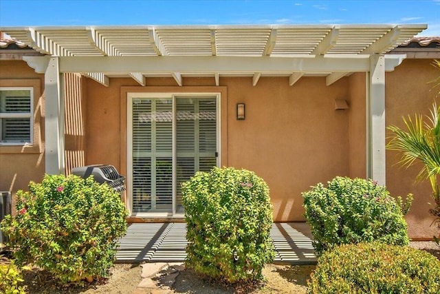 entrance to property with a pergola