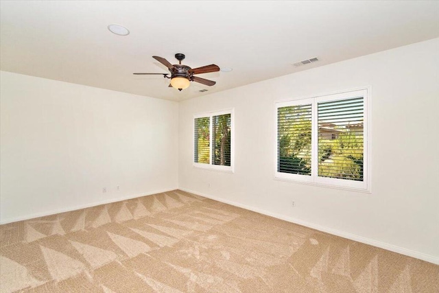 spare room with light carpet and ceiling fan