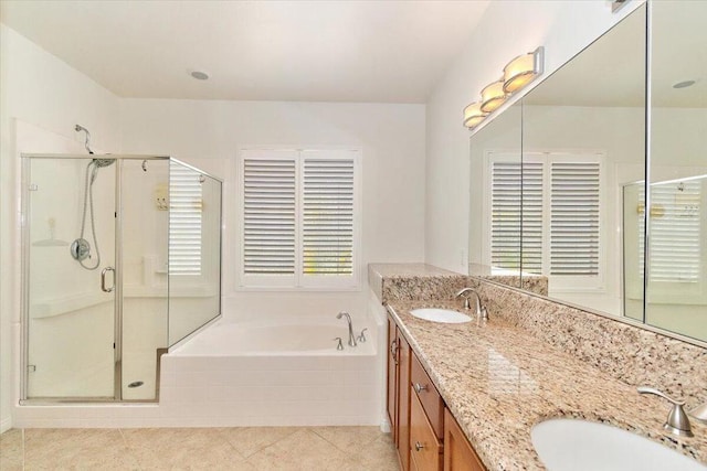 bathroom with tile patterned flooring, vanity, and separate shower and tub