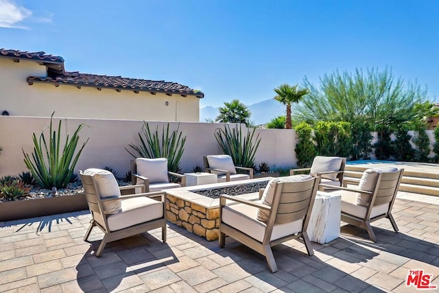 view of patio / terrace featuring an outdoor fire pit