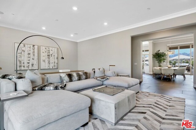 living room featuring light hardwood / wood-style floors and ornamental molding