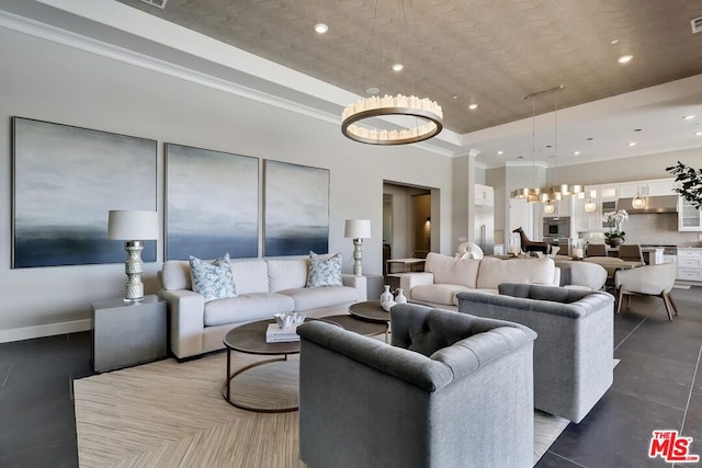 living room with ornamental molding and a notable chandelier