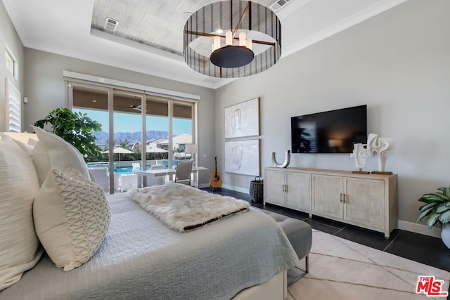 bedroom with access to outside and dark tile patterned floors