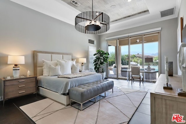 tiled bedroom with access to exterior and a towering ceiling