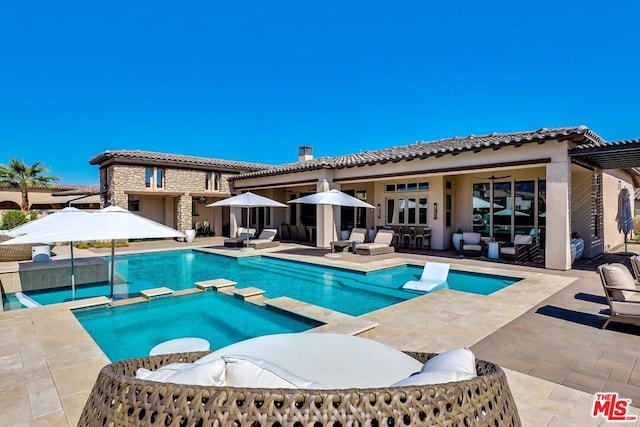 view of swimming pool with an in ground hot tub and a patio