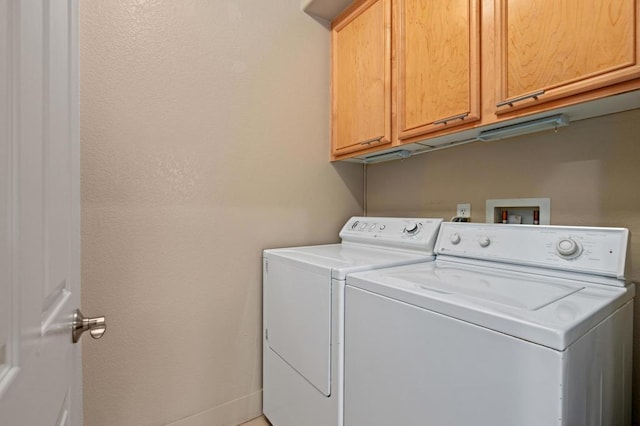 laundry area with cabinets and separate washer and dryer