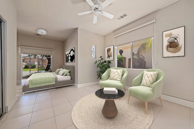 bedroom with ceiling fan and light tile patterned floors