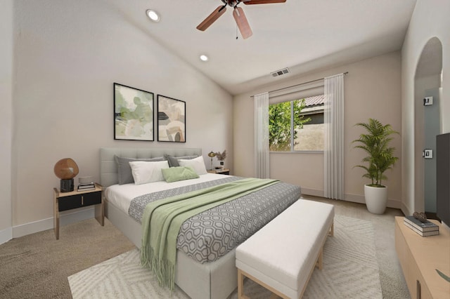 carpeted bedroom with ceiling fan and vaulted ceiling