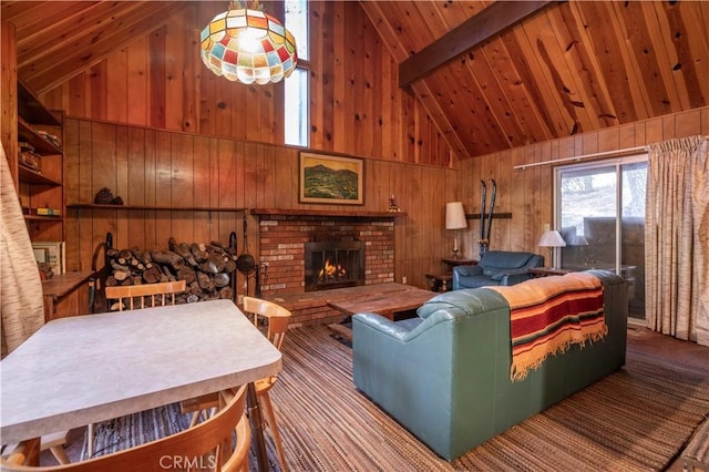 living room with high vaulted ceiling, wooden walls, a fireplace, beam ceiling, and wood ceiling