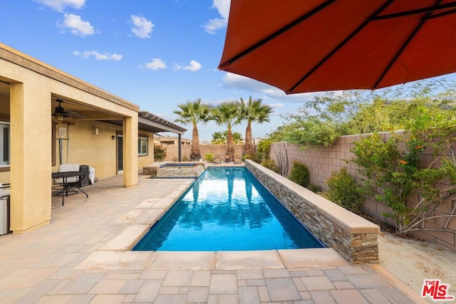 view of pool featuring ceiling fan, a patio area, and an in ground hot tub