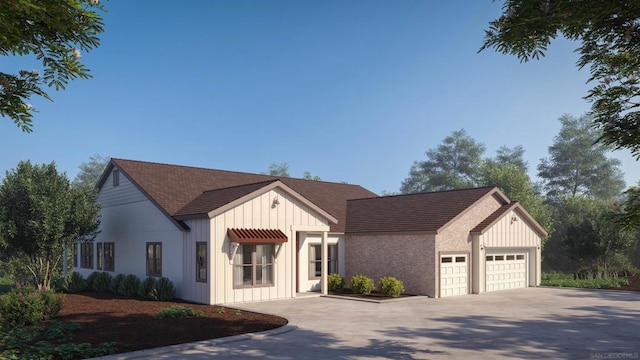 modern inspired farmhouse with a garage