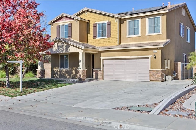 view of front of property with solar panels and a garage