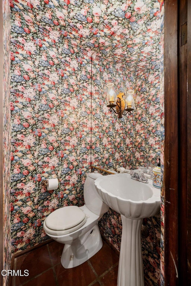 bathroom with toilet and tile patterned floors