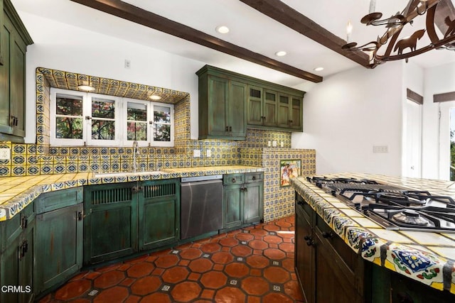 kitchen with beamed ceiling, decorative backsplash, stainless steel appliances, and green cabinetry