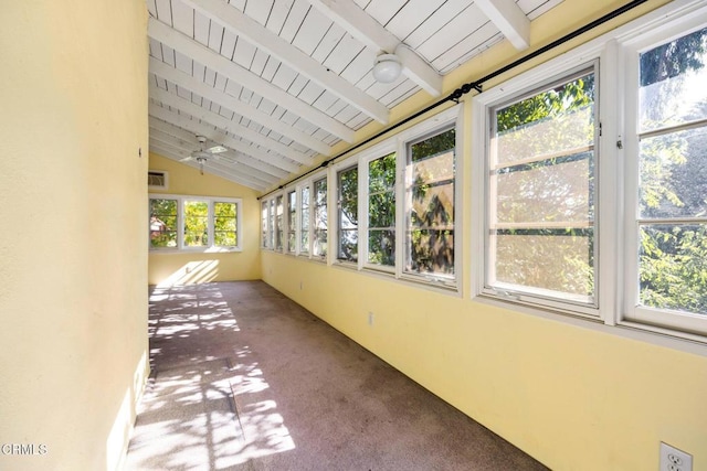 unfurnished sunroom with wooden ceiling, plenty of natural light, and lofted ceiling with beams