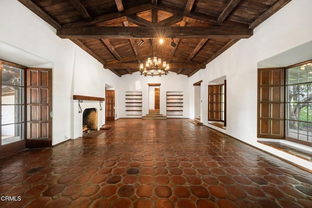 unfurnished living room with beamed ceiling, wooden ceiling, and high vaulted ceiling