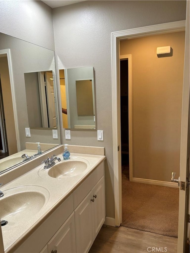 bathroom featuring vanity and wood-type flooring