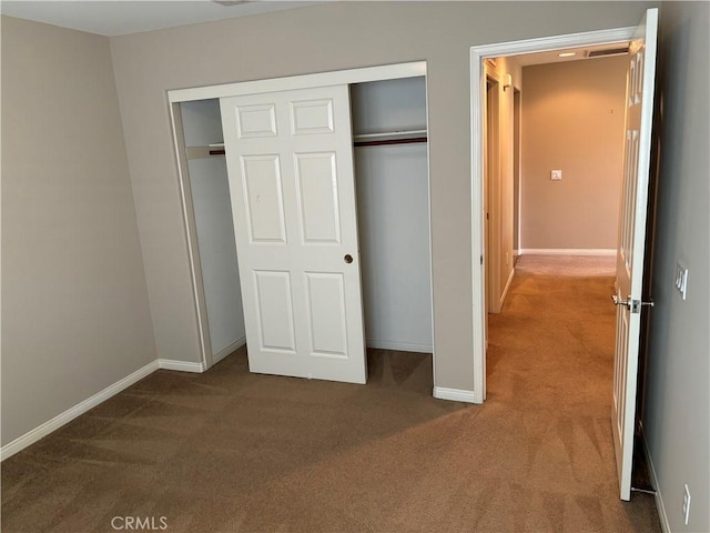 unfurnished bedroom featuring a closet and carpet