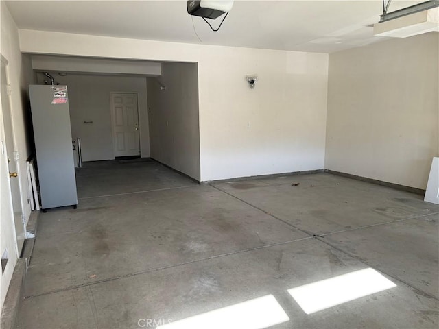 garage with white refrigerator and a garage door opener