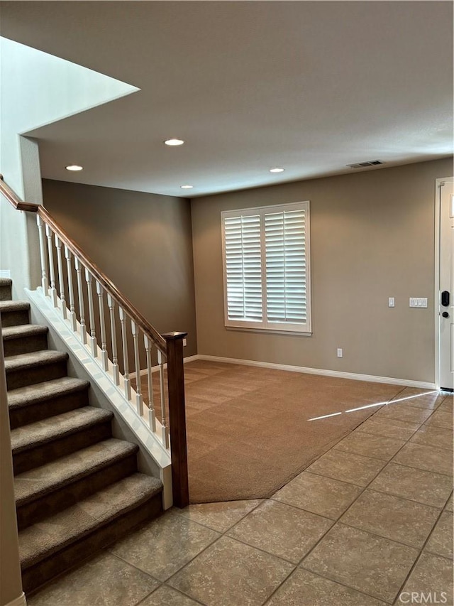 stairway featuring carpet floors