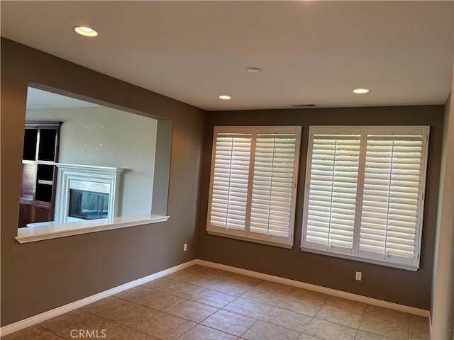 unfurnished room with light tile patterned floors